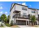 Modern townhome exterior featuring a two-car garage, balcony, and contemporary curb appeal at 4776 Highside Way, Smyrna, GA 30082