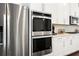 Stainless steel appliances and white cabinetry in a modern kitchen at 4776 Highside Way, Smyrna, GA 30082