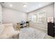Bright home office with modern desk setup, comfortable couch, and ample natural light at 4776 Highside Way, Smyrna, GA 30082