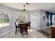 Bright dining area with a view of the backyard, featuring a wood table and tiled floor at 6675 Princeton Park Ct, Lithonia, GA 30058