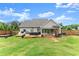 Spacious backyard showcasing a patio, outdoor furniture, and lush green lawn at 7820 Longview Dr, Cumming, GA 30041