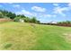 Expansive backyard with lush lawn, privacy fence, and a storage shed at 7820 Longview Dr, Cumming, GA 30041