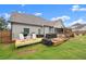 Backyard patio with grill, seating and manicured lawn at 7820 Longview Dr, Cumming, GA 30041