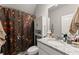 A bathroom with a whimsical shower curtain featuring botanical and animal designs at 7820 Longview Dr, Cumming, GA 30041