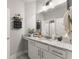Stylish bathroom featuring white cabinets, granite counters, modern light fixtures, and a large mirror at 7820 Longview Dr, Cumming, GA 30041