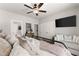 Spacious bedroom featuring a comfortable sitting area, ceiling fan, and generous closet space at 7820 Longview Dr, Cumming, GA 30041