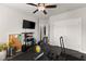 Bedroom features a ceiling fan, TV, exercise equipment, and double door closet at 7820 Longview Dr, Cumming, GA 30041