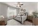 Comfortable bedroom with a wrought iron bed frame, ceiling fan, and natural light from the window at 7820 Longview Dr, Cumming, GA 30041