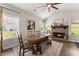 Comfortable dining room with brick fireplace, hardwood floors, and natural light from nearby windows at 7820 Longview Dr, Cumming, GA 30041