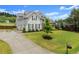 Home with well-manicured lawn, two-car garage, with a professionally landscaped yard, creating a welcoming entrance at 7820 Longview Dr, Cumming, GA 30041