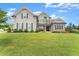 Beautiful two-story home featuring manicured lawn, complemented by modern gray siding and well-placed shrubbery at 7820 Longview Dr, Cumming, GA 30041