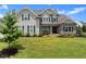 Charming two-story home with landscaped front yard, inviting curb appeal, and a classic architectural design at 7820 Longview Dr, Cumming, GA 30041