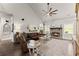 Comfortable living room with brick fireplace, ceiling fan, and natural light from nearby windows at 7820 Longview Dr, Cumming, GA 30041