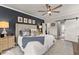 Cozy main bedroom with barn door to ensuite bathroom and navy accent wall at 7820 Longview Dr, Cumming, GA 30041