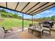 Inviting covered patio with comfortable seating and views of the fenced backyard at 7820 Longview Dr, Cumming, GA 30041