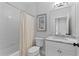This bathroom features a white tiled shower, toilet, and marble vanity sink at 2196 Niles Ne Pl, Atlanta, GA 30324