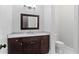 Bathroom vanity with dark wood cabinets, marble countertop and decorative mirror at 2196 Niles Ne Pl, Atlanta, GA 30324
