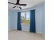 Spare bedroom featuring a ceiling fan, neutral carpet, and large window at 2196 Niles Ne Pl, Atlanta, GA 30324