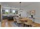 Stylish dining area open to a modern kitchen, featuring hardwood floors and contemporary light fixtures at 2196 Niles Ne Pl, Atlanta, GA 30324