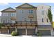 Modern townhome exterior with gray siding, a balcony, and attached garage at 2196 Niles Ne Pl, Atlanta, GA 30324