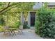 Charming home featuring a cozy outdoor seating area surrounded by lush greenery and a black front door at 2196 Niles Ne Pl, Atlanta, GA 30324
