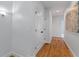 Bright hallway featuring hardwood floors and a large closet with shaker doors at 2196 Niles Ne Pl, Atlanta, GA 30324