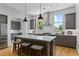 Modern kitchen with a large island, stainless steel appliances, gray cabinets, and bright white subway tile backsplash at 2196 Niles Ne Pl, Atlanta, GA 30324