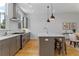 Modern kitchen with gray cabinets, stainless steel appliances, granite countertops, and natural lighting at 2196 Niles Ne Pl, Atlanta, GA 30324