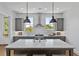 Well-lit kitchen featuring gray cabinets, a marble island, stainless steel appliances, and subway tile backsplash at 2196 Niles Ne Pl, Atlanta, GA 30324