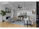 Bright living room featuring hardwood floors, fireplace, and a seamless transition to the dining area and kitchen at 2196 Niles Ne Pl, Atlanta, GA 30324