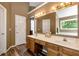 Dual sink bathroom featuring hardwood floors, walk-in shower and a tub at 2621 Garland Way, Duluth, GA 30096