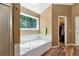 Bathroom featuring a jacuzzi tub, walk in shower, and a walk-in closet at 2621 Garland Way, Duluth, GA 30096