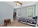 Bedroom with blue walls, ceiling fan, and a bed with a blue and white quilt at 2621 Garland Way, Duluth, GA 30096