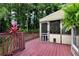 View of the deck leading to the screened in porch and the surrounding greenery at 2621 Garland Way, Duluth, GA 30096