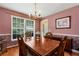 Traditional dining room with chandelier lighting and wood floors, great for Gathering meals at 2621 Garland Way, Duluth, GA 30096