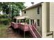 Back exterior view showcasing upper deck, screened in porch, and the home's siding at 2621 Garland Way, Duluth, GA 30096