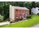Beautiful brick home with red shutters, a landscaped front yard, and attached garage at 2621 Garland Way, Duluth, GA 30096
