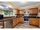 Bright kitchen with stainless steel appliances, wooden cabinetry, and a view to the outdoors at 2621 Garland Way, Duluth, GA 30096