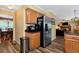 Kitchen with stainless steel refrigerator, wooden cabinets, and eat-in dining space at 2621 Garland Way, Duluth, GA 30096