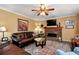 Cozy living room featuring a brick fireplace, plush seating and decorative rug at 2621 Garland Way, Duluth, GA 30096