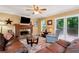 Inviting living room with a brick fireplace, neutral walls, and access to the outdoor deck at 2621 Garland Way, Duluth, GA 30096