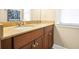 Bathroom featuring a double sink vanity with brown cabinets and tan countertops at 3460 Drayton Manor Run, Lawrenceville, GA 30046