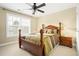 Bedroom with a ceiling fan, carpet, and a double bed, creating a cozy and inviting atmosphere at 3460 Drayton Manor Run, Lawrenceville, GA 30046
