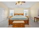 Cozy bedroom with a classic wooden bed, soft lighting, and a large window creates a tranquil and inviting atmosphere at 3460 Drayton Manor Run, Lawrenceville, GA 30046