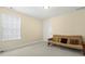 Bedroom features a futon, neutral walls, and a bright window at 3460 Drayton Manor Run, Lawrenceville, GA 30046