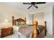Well-lit bedroom with wood furniture, plush bedding, and access to a closet offers a cozy and inviting space at 3460 Drayton Manor Run, Lawrenceville, GA 30046