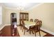 Well-lit dining room with hardwood floors, a formal table and chair set, and a china cabinet at 3460 Drayton Manor Run, Lawrenceville, GA 30046