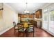 Eat-in kitchen area with wood floors, a table with seating for four, and natural light at 3460 Drayton Manor Run, Lawrenceville, GA 30046