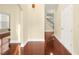 Bright entryway with beautiful hardwood floors and fresh paint that leads to a staircase and a view of the living space at 3460 Drayton Manor Run, Lawrenceville, GA 30046