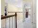 Bright hallway with carpet floors, natural light and wooden banister at 3460 Drayton Manor Run, Lawrenceville, GA 30046